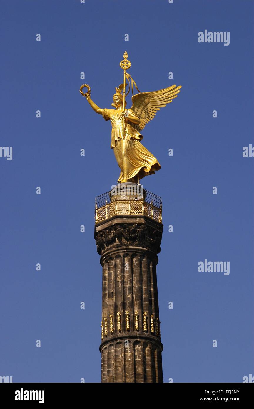 Germany, Berlin, Tiergarten, Siegessaeule, gold statue of winged woman personifying Victory, on top of column Stock Photo