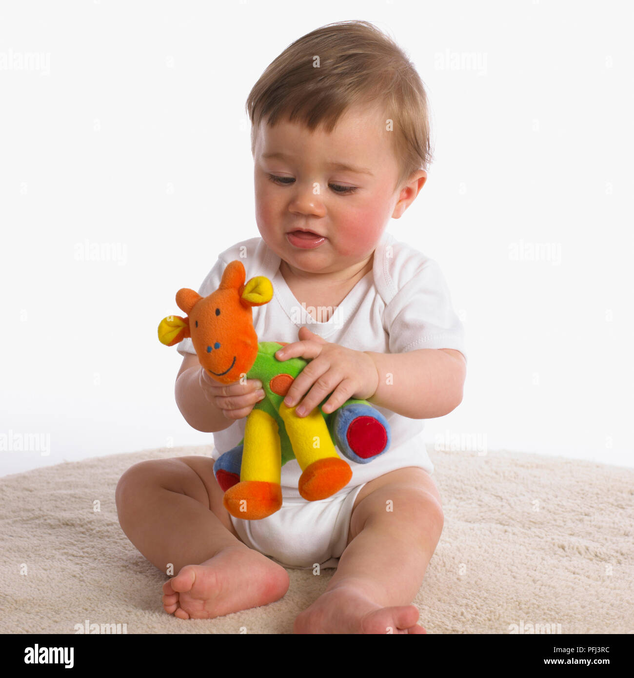 Baby holding toy sales