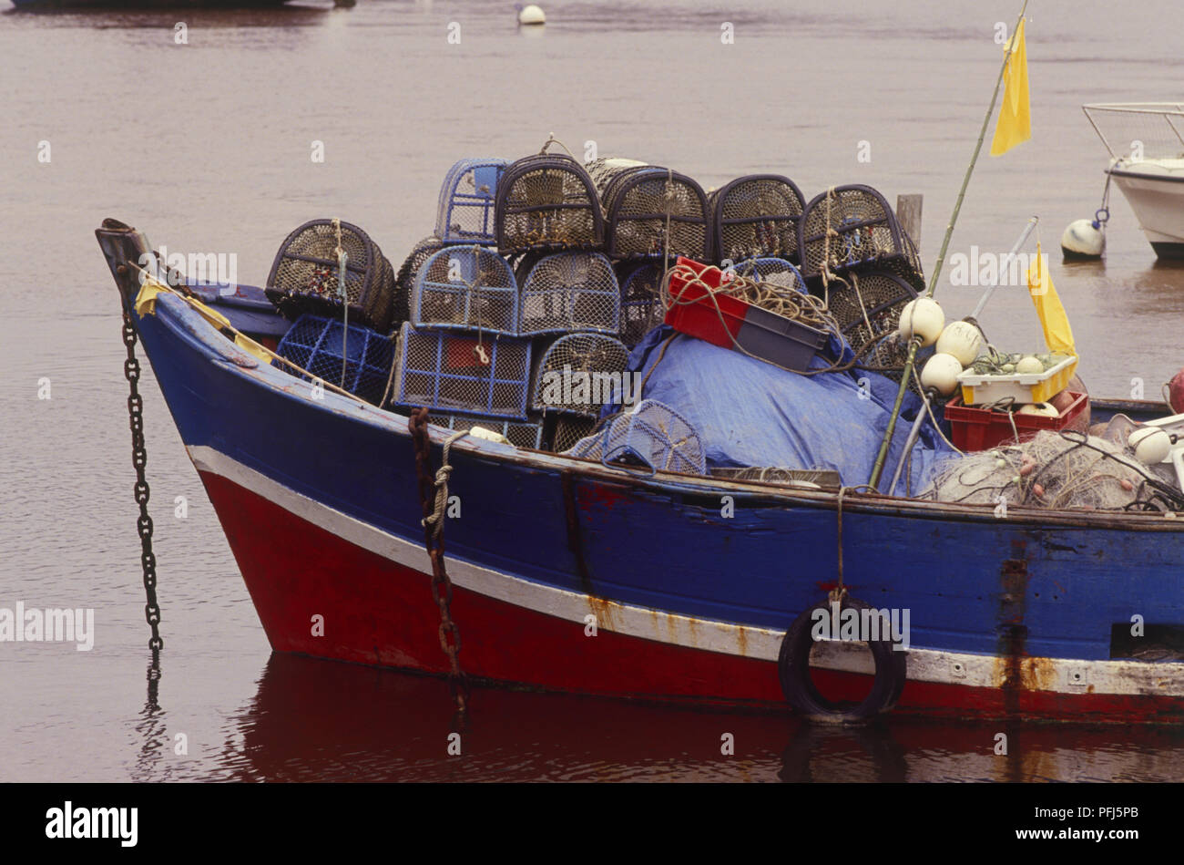France, Brittany, Le Pouldou harbour, boat loaded with fishing tackle and lobster cages Stock Photo