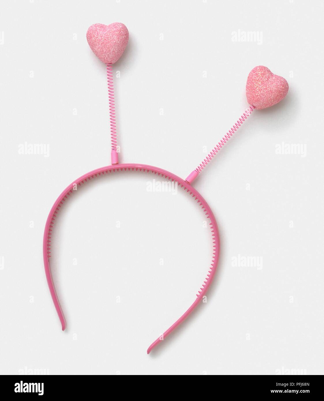 Pink plastic head band with heartshaped antennae Stock Photo Alamy