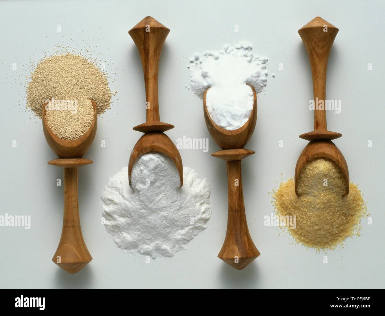 Four wooden spoons of ground yeast and gelatine, baking powder, and