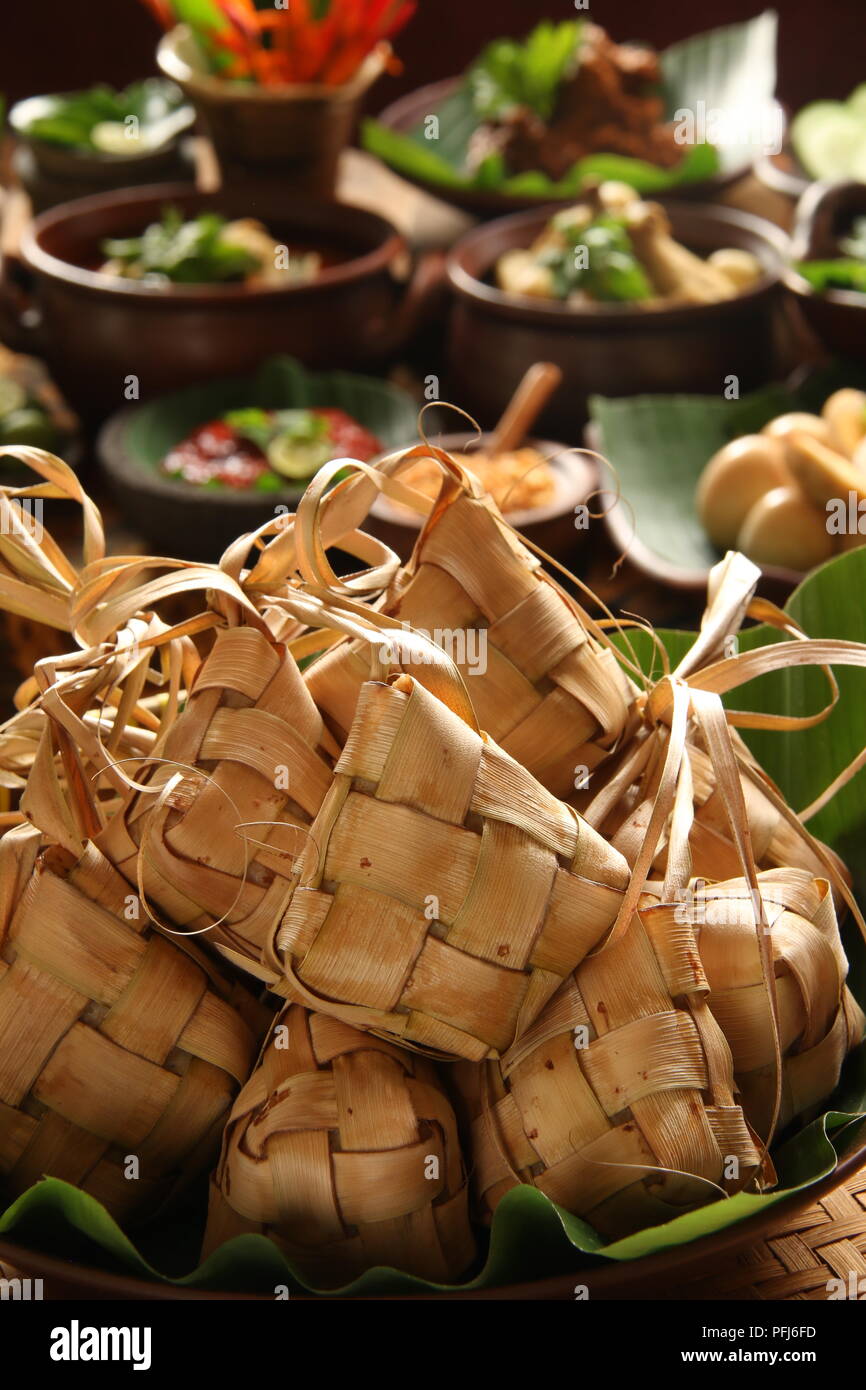 Ketupat Lebaran, the traditional celebratory dish of rice cake with several side dishes; popular during Eid celebrations. Stock Photo