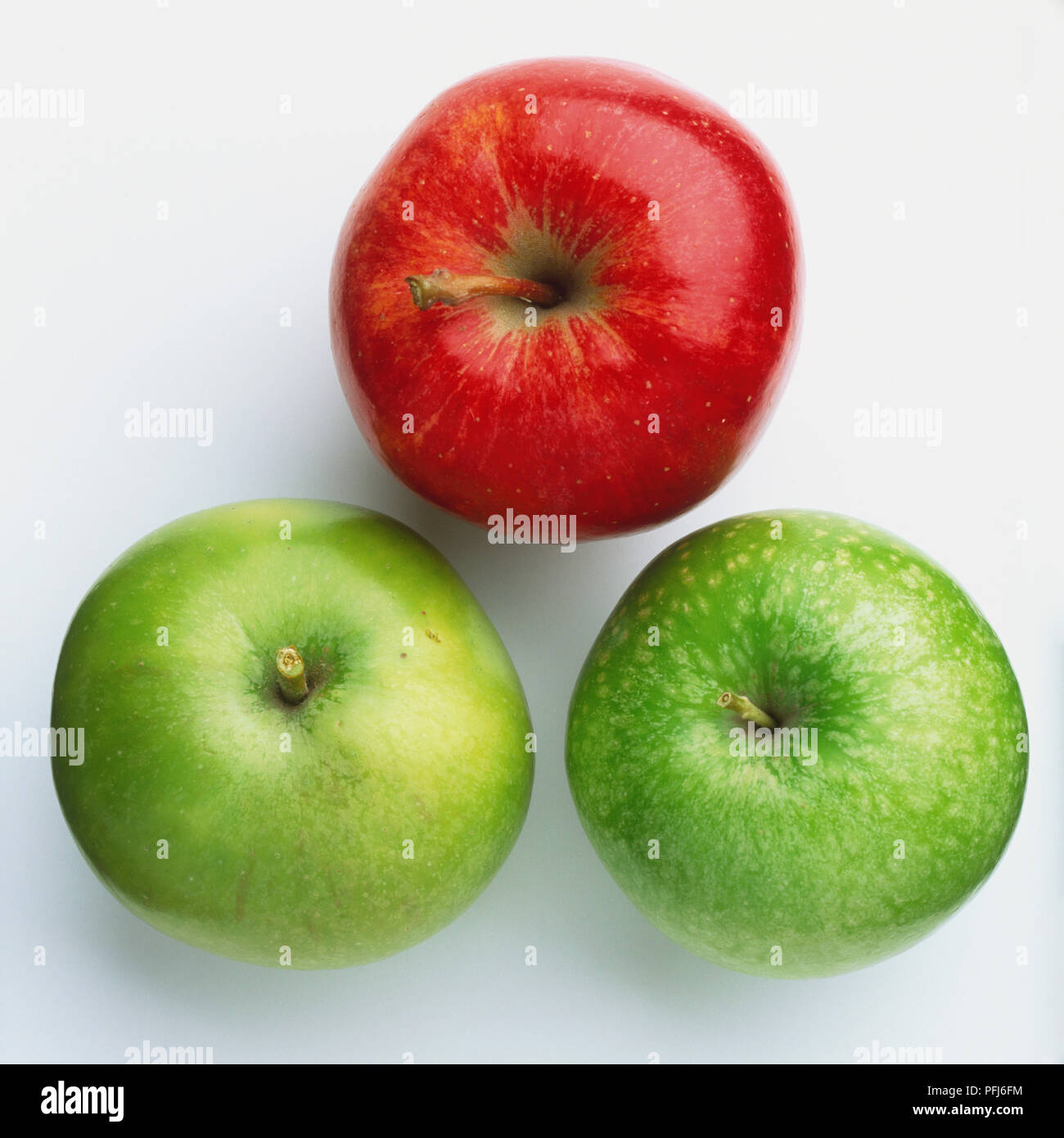 Three apples, one red, two green Stock Photo