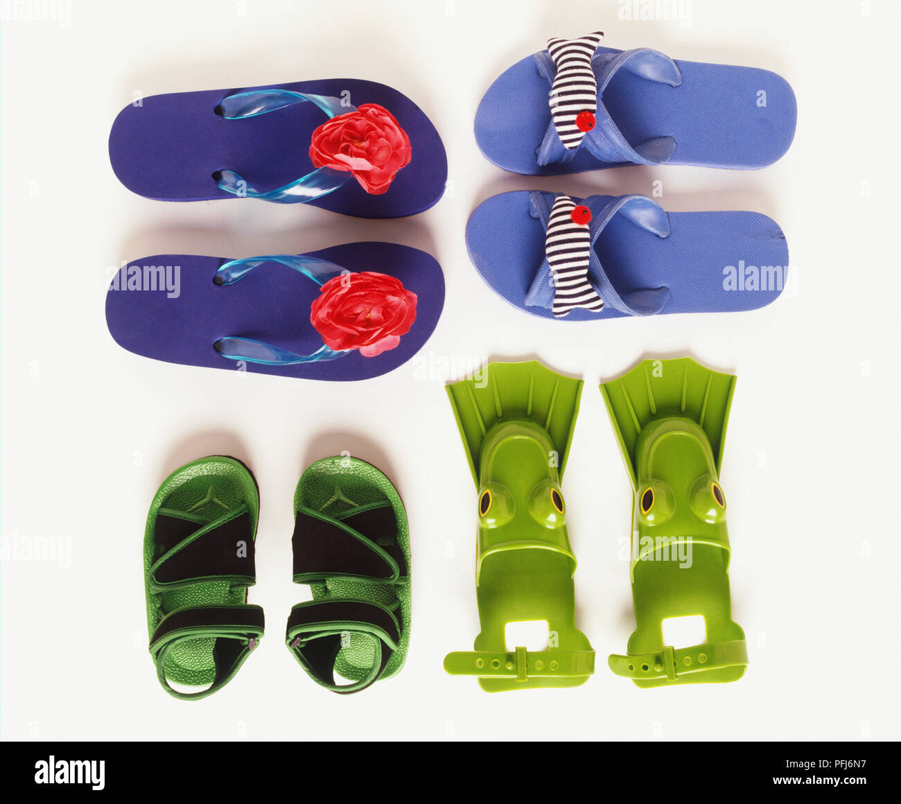 Three pairs of flip flops and green flippers Stock Photo - Alamy