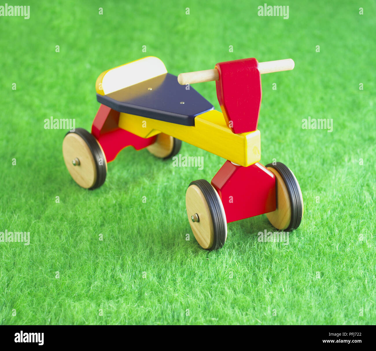 Wooden toy quadracycle, close up. Stock Photo