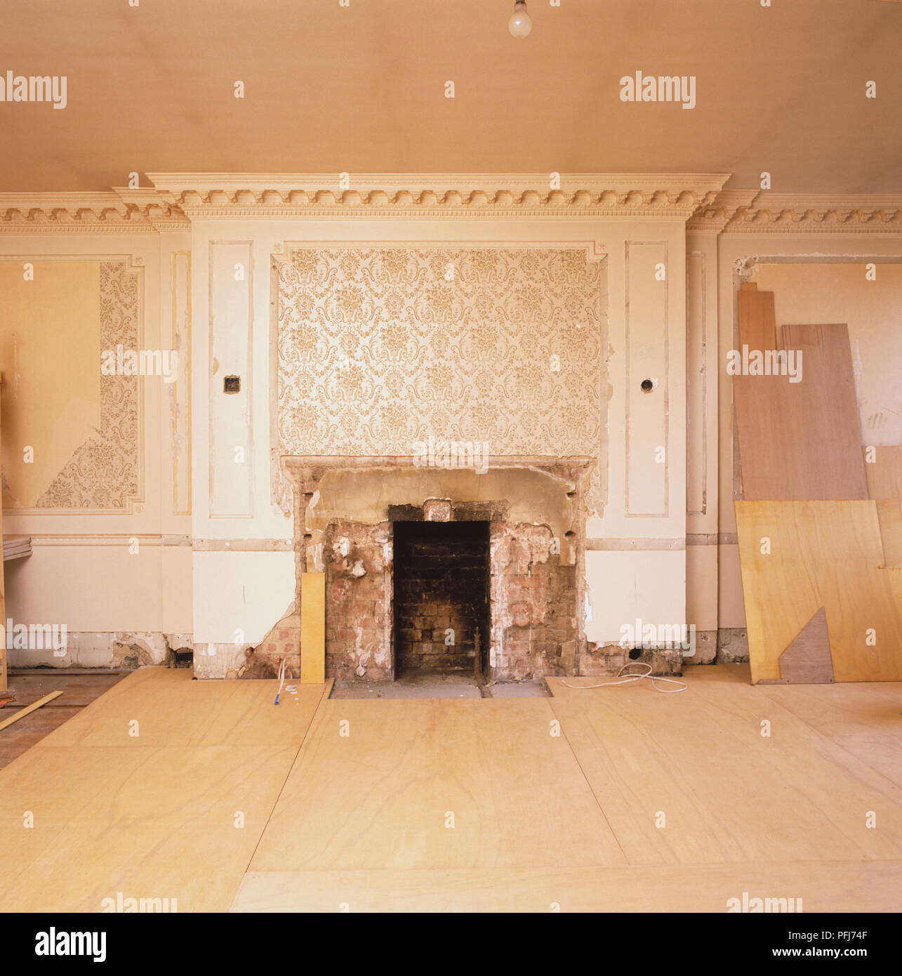 Fireplace with its hearth removed. Stock Photo