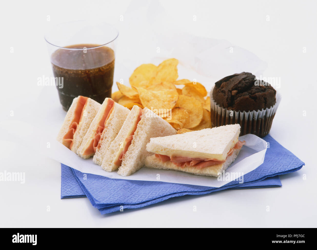 Triangular Muffin Glass of cola, triangular ham sandwiches without crust, crisps ...