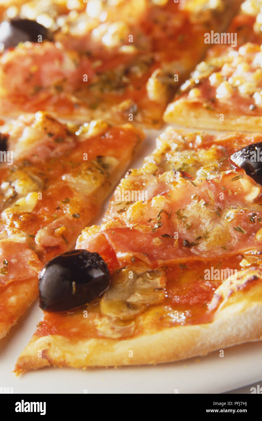 La Reine Pizza Round Pizza Sliced With Thin Crispy Crust Topped With Mushroom Slices Ham Whole Olives Finely Chopped Garlic Tomato Sauce And Cheese Section Stock Photo Alamy