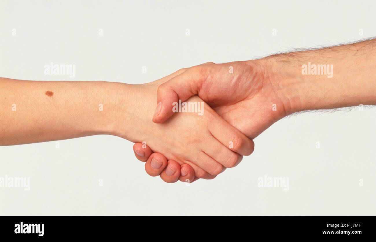 Outstretched man's and woman's arm, shaking hands Stock Photo Alamy