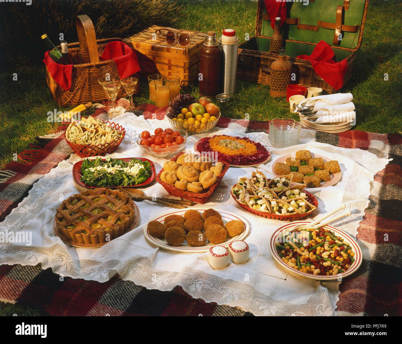 Picnic display, baskets, thermos flasks, bottles, glasses, bowls and