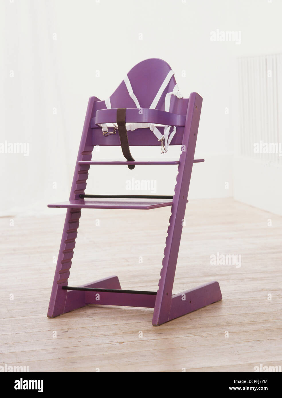 Purple high chair with safety harness and black strap Stock Photo Alamy