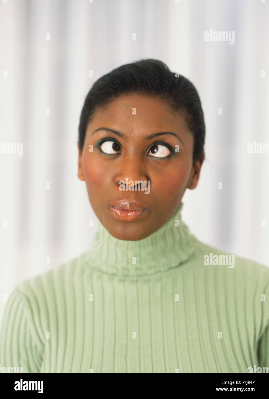 Woman with her eyes crossed and pursed lips Stock Photo Alamy