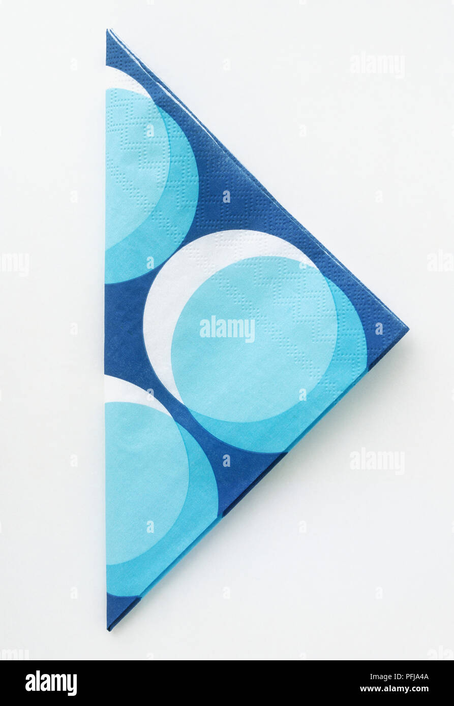 Folded paper napkin with a blue and white circle design Stock Photo