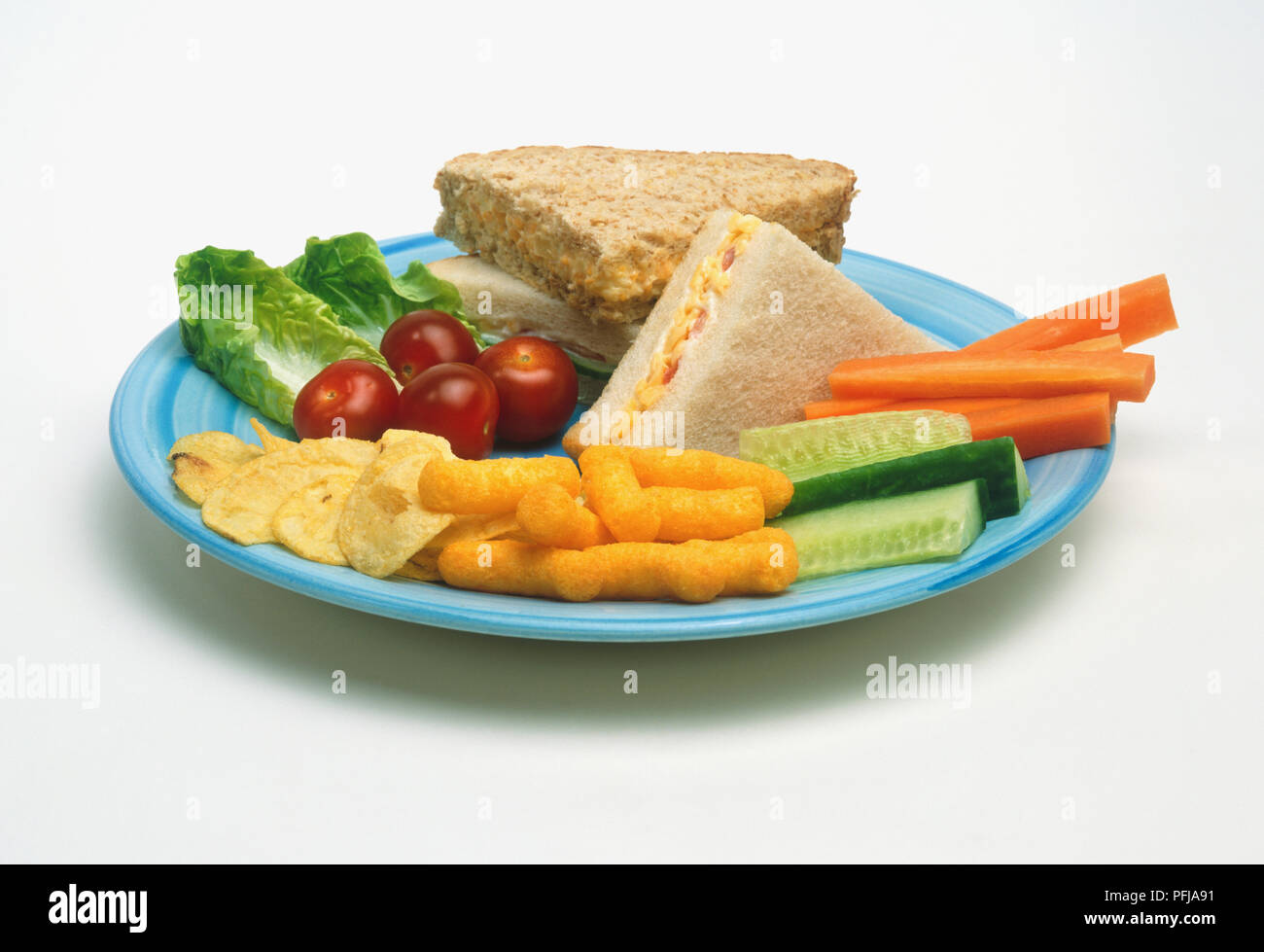 Two sandwiches, made with white and wholemeal bread, and carrots