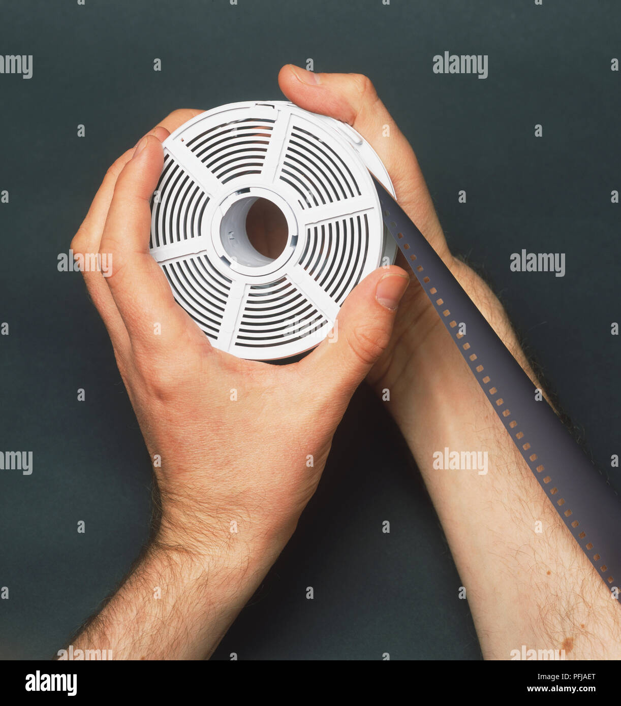 35mm film being fed onto a reel Stock Photo Alamy