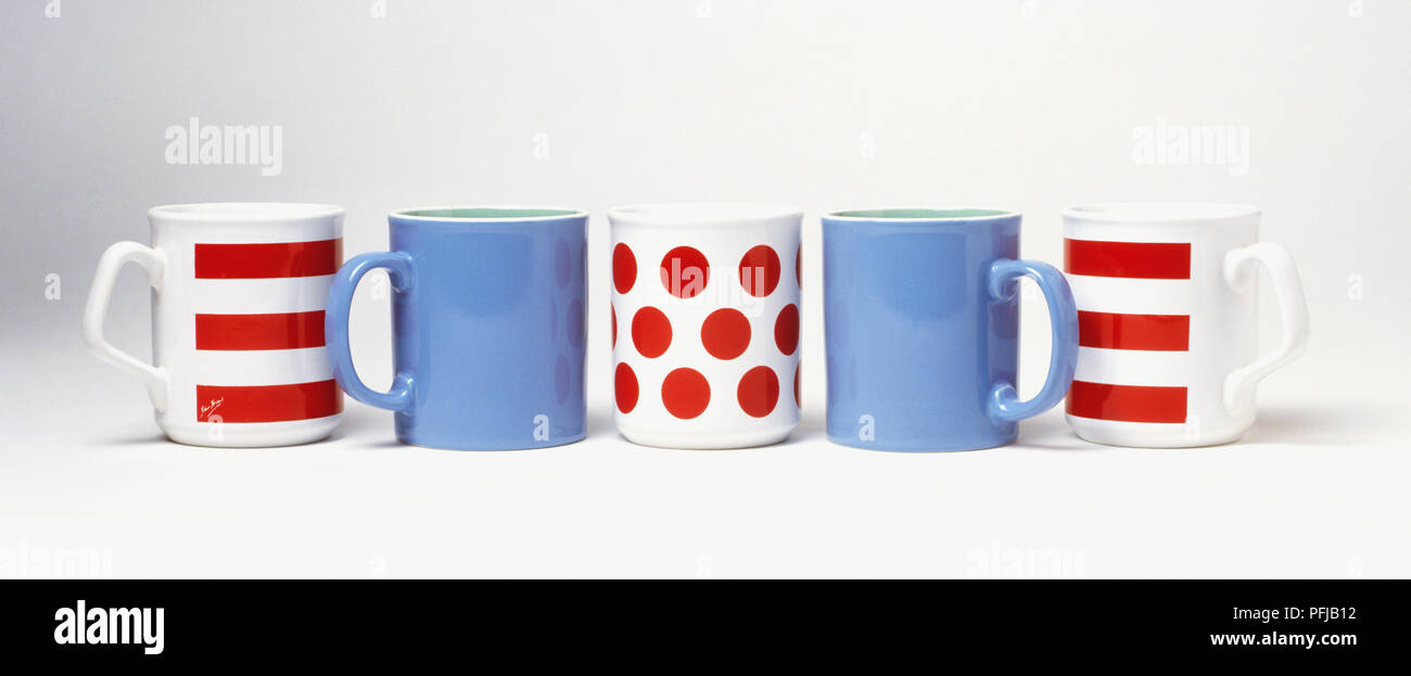 Five coffee mugs, striped, spotted and plain Stock Photo