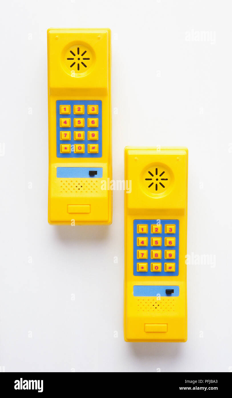 Two cordless yellow phone receivers, front view Stock Photo Alamy