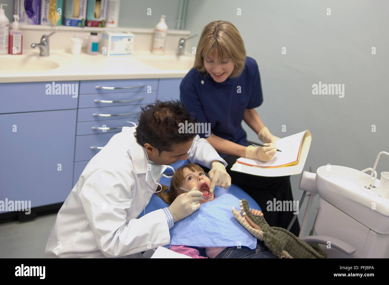 dentist examining girls teeth dental nurse taking notes stock dentist nurse