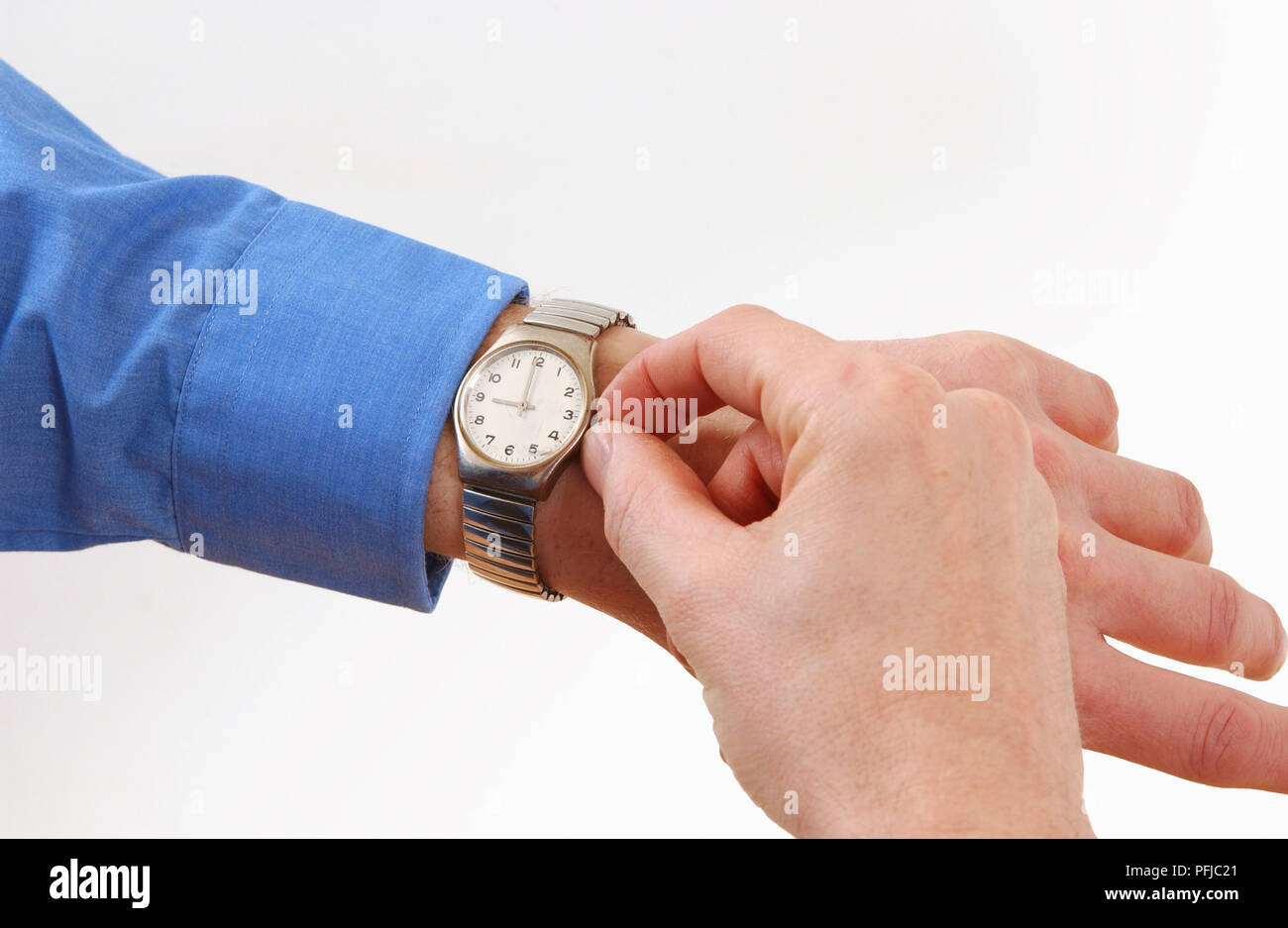 Man's hand setting wristwatch, close-up Stock Photo - Alamy
