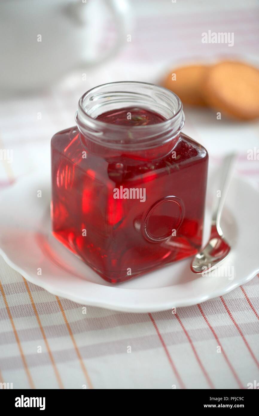 Lavender jelly in jar on plate Stock Photo