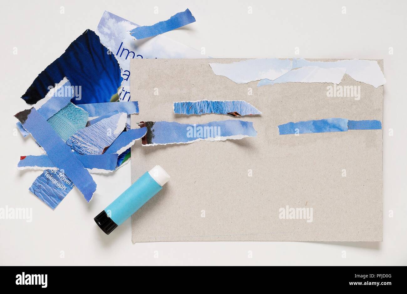 Pieces of torn paper and glue stick used to create collage Stock Photo -  Alamy