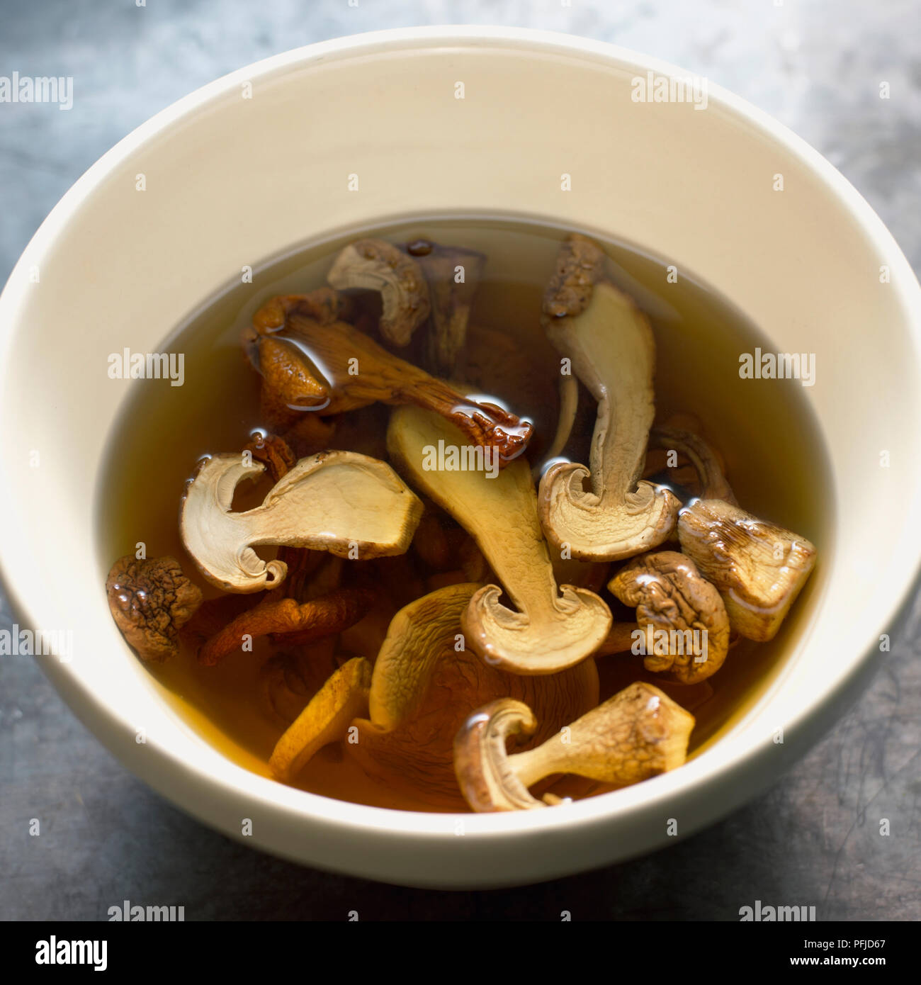 Bowl of dried mushrooms soaking in water Stock Photo Alamy