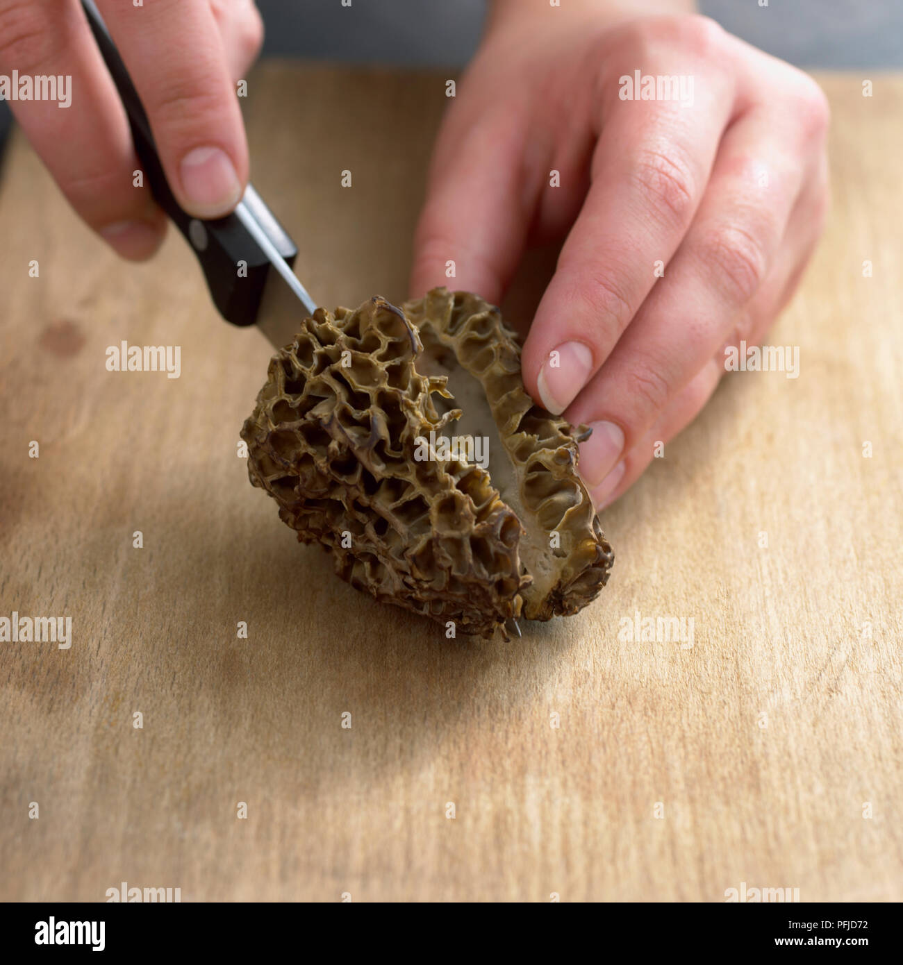 Cutting morel mushroom in half, closeup Stock Photo Alamy