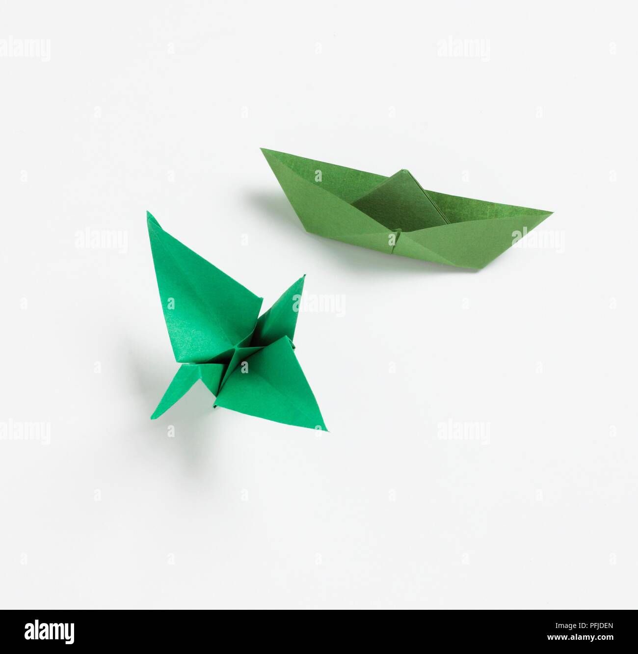 Green origami boat and green origami bird Stock Photo