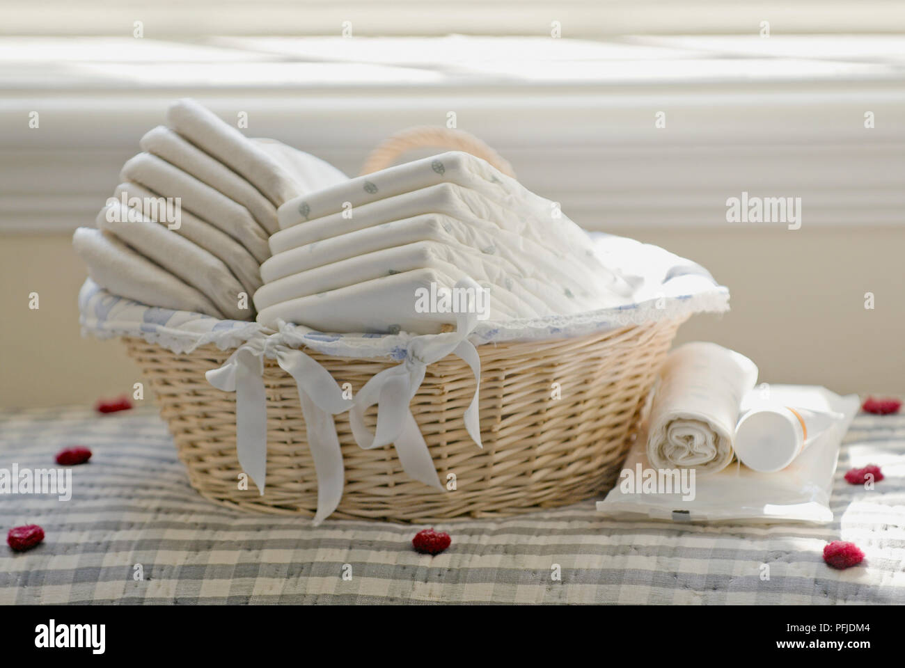 Nappies in wicker basket in front of window sill Stock Photo Alamy