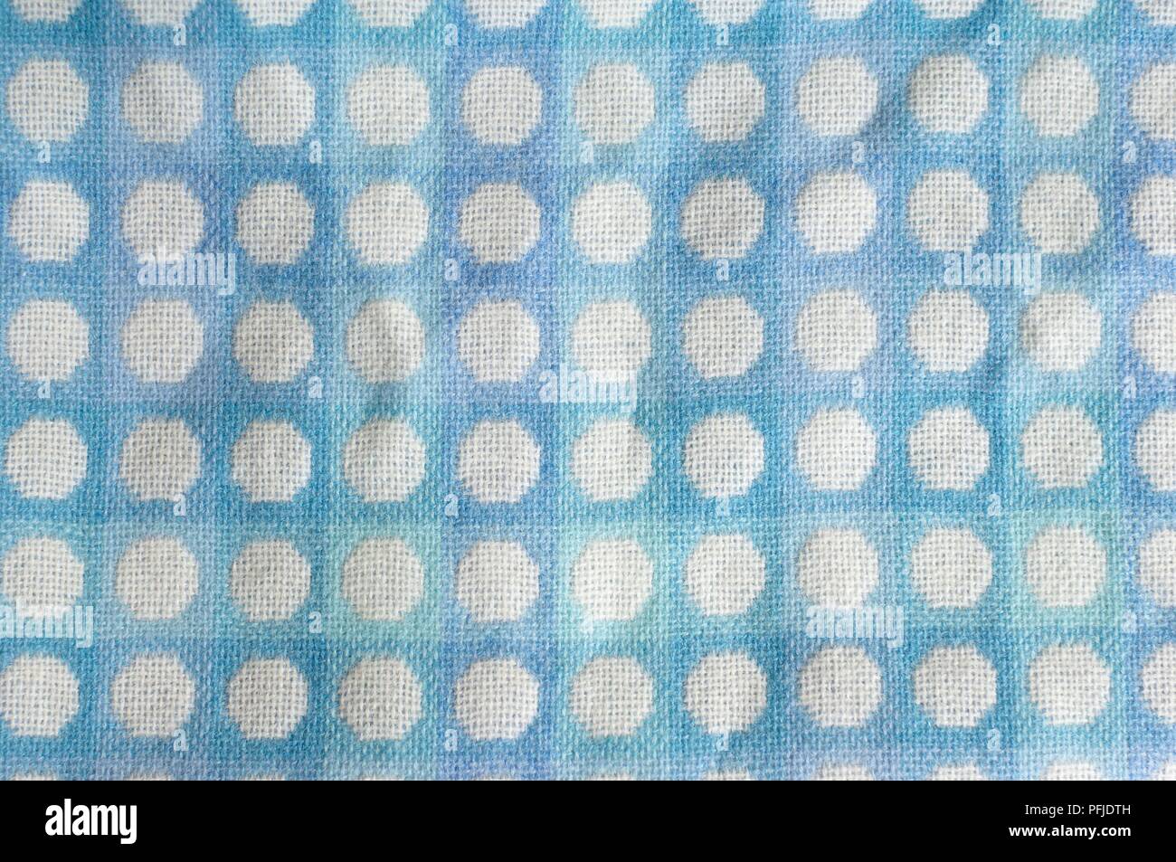 Patterned fabric, blue with white dots Stock Photo