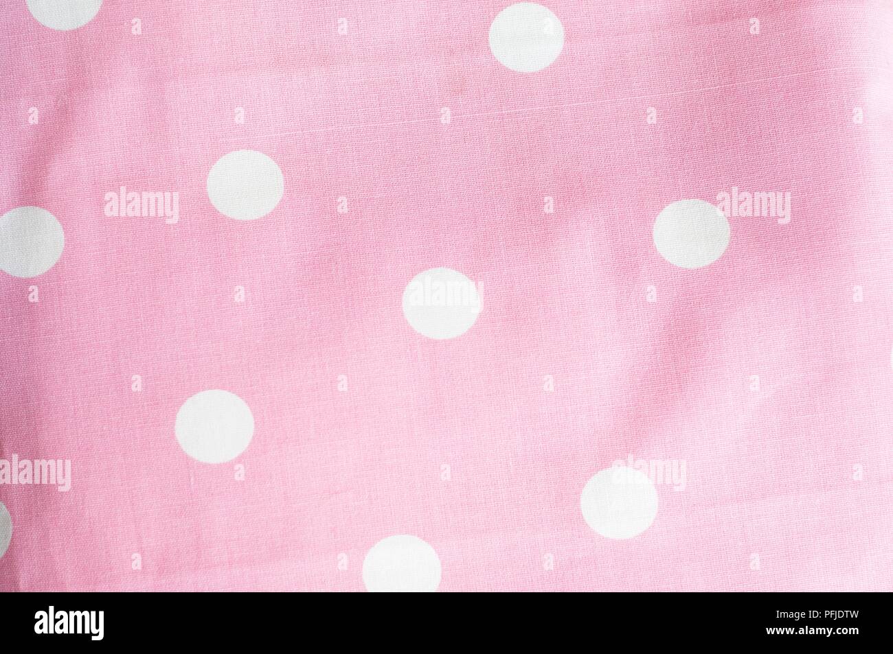 Patterned fabric, pink with white polka dots Stock Photo