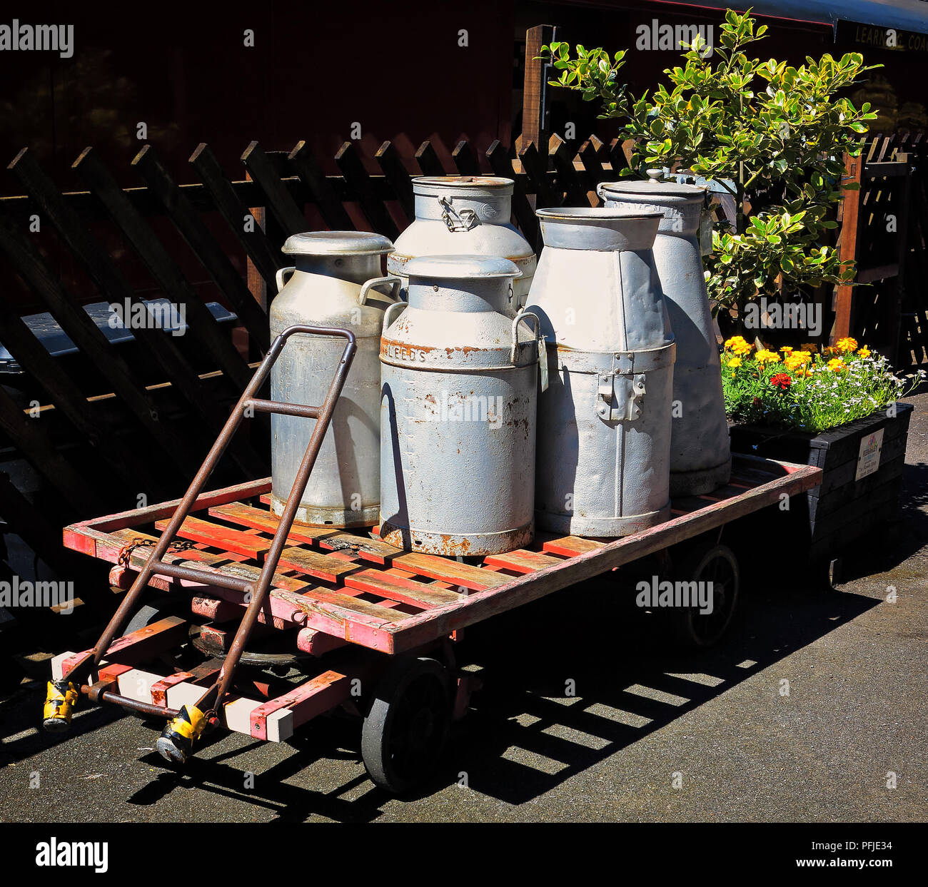 Milk churns on a trolley at Ingrow Station, on the KWVR line Stock Photo