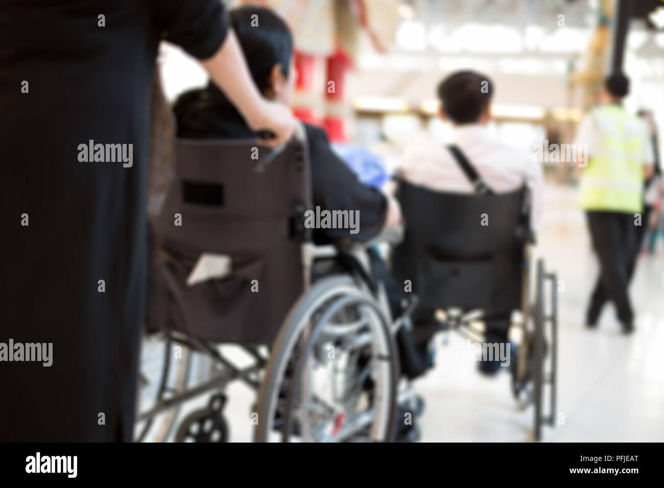 Blurred concept elderly people in wheelchair waiting at the airport Stock Photo