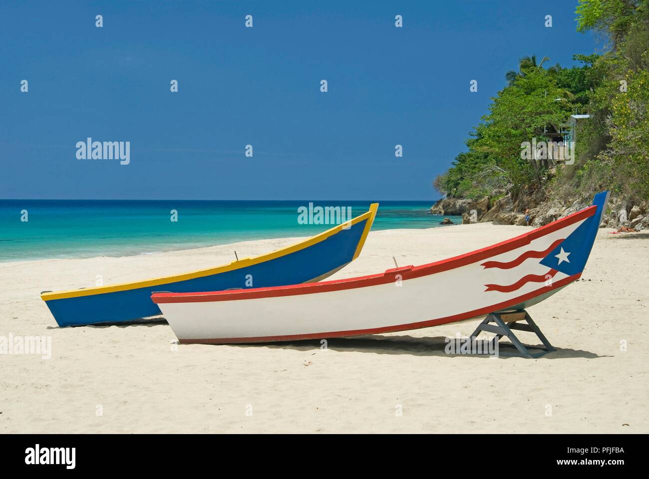 Puerto Rico, Playa Crash Boat, two colourful boats on sandy beach Stock Photo