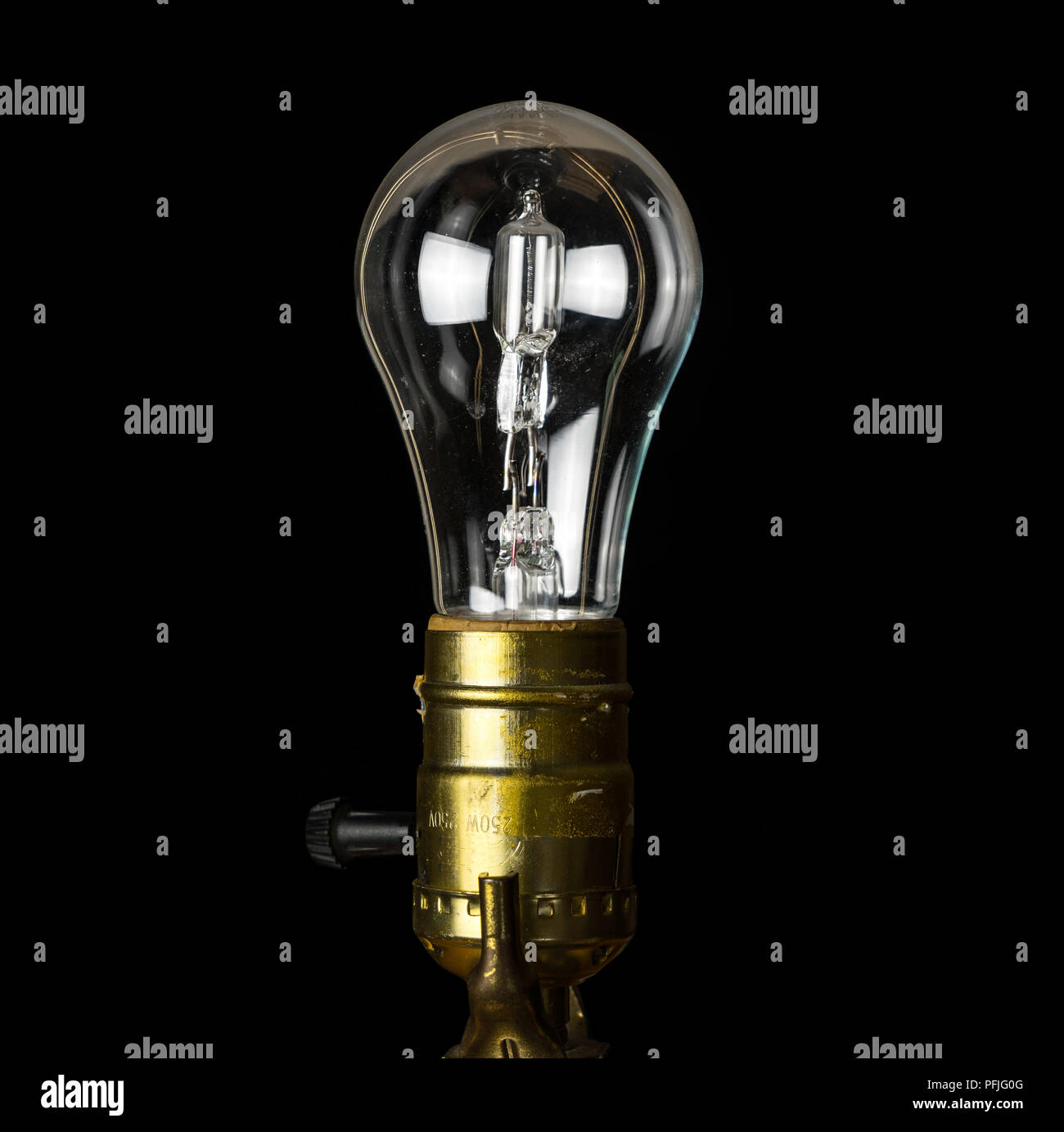Brass light holder with a halogen lightbulb soon to be banned in EU Stock Photo