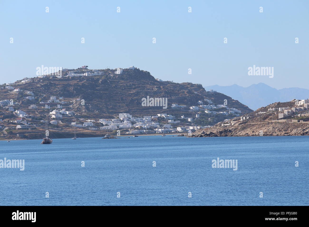 View of the island of Mykonos from a distance showing villages on the hills Stock Photo