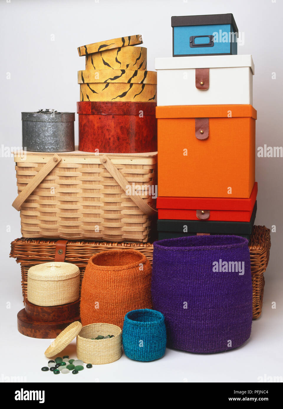Colourful selection of storage boxes and baskets made of cardboard and wicker. Stock Photo