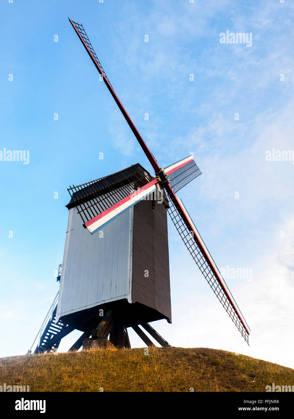 Sint-Janshuismolen windmill grinding grain in its original location since 1770 - Bruges, Belgium Stock Photo
