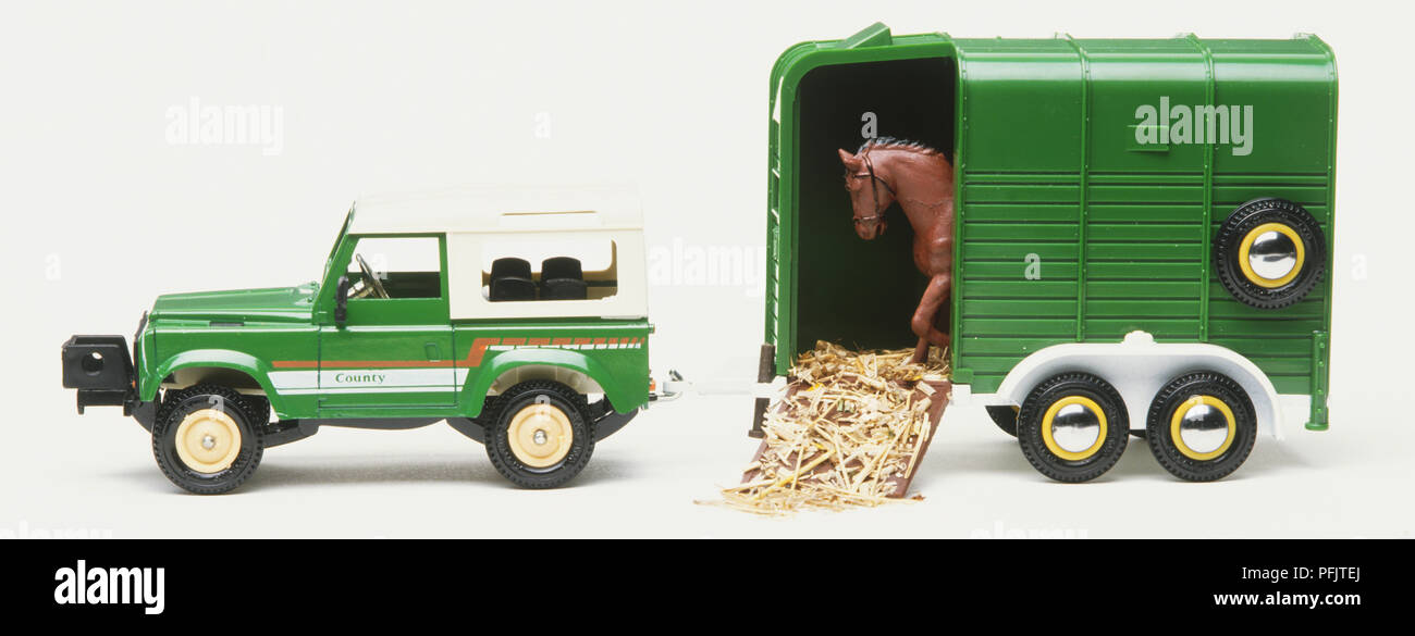 Toy off-road vehicle and horse trailer, side view Stock Photo