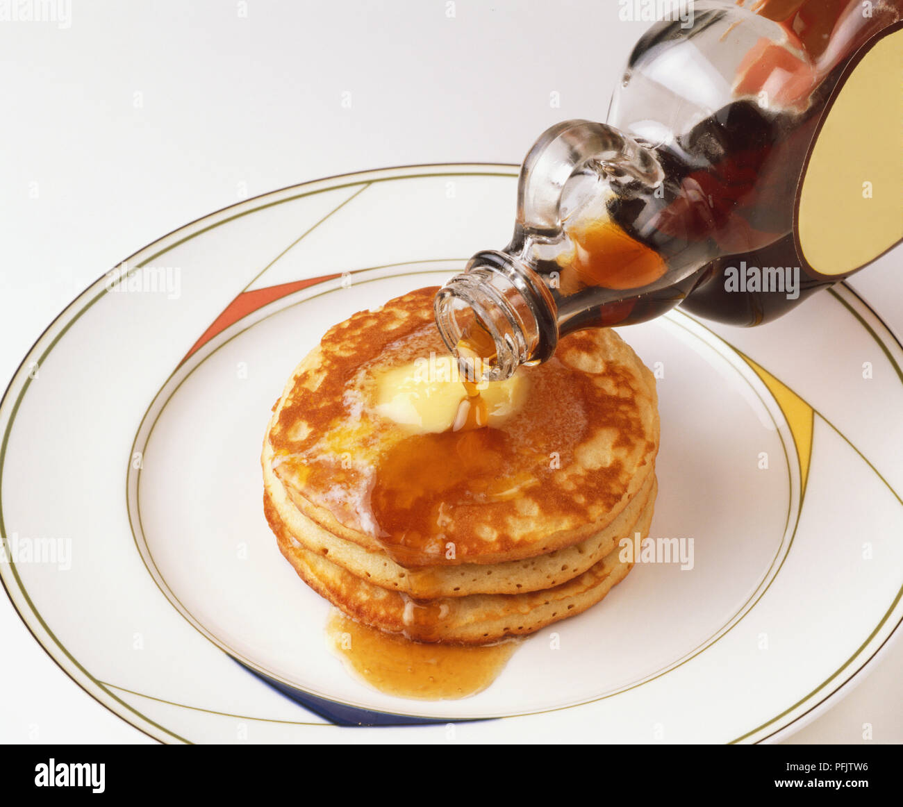 Pouring maple syrup over pancakes Stock Photo Alamy
