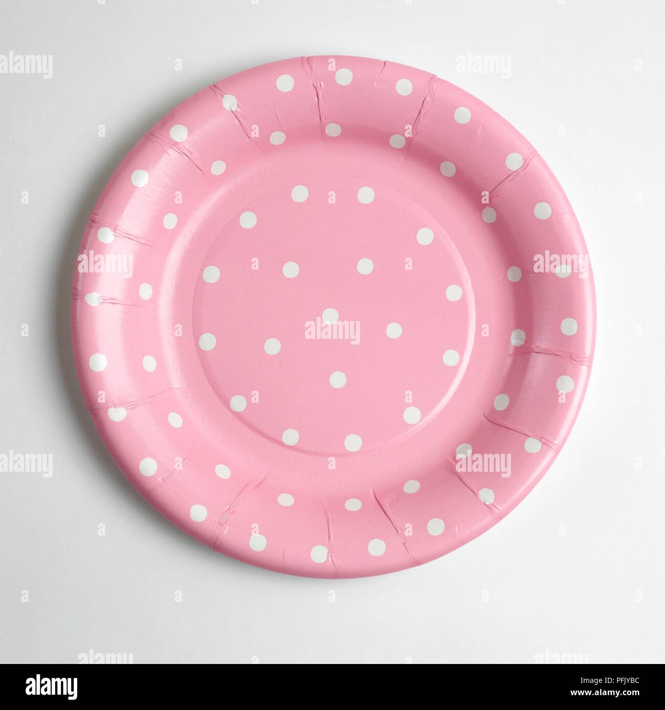 Pink paper plate with white polka dots Stock Photo