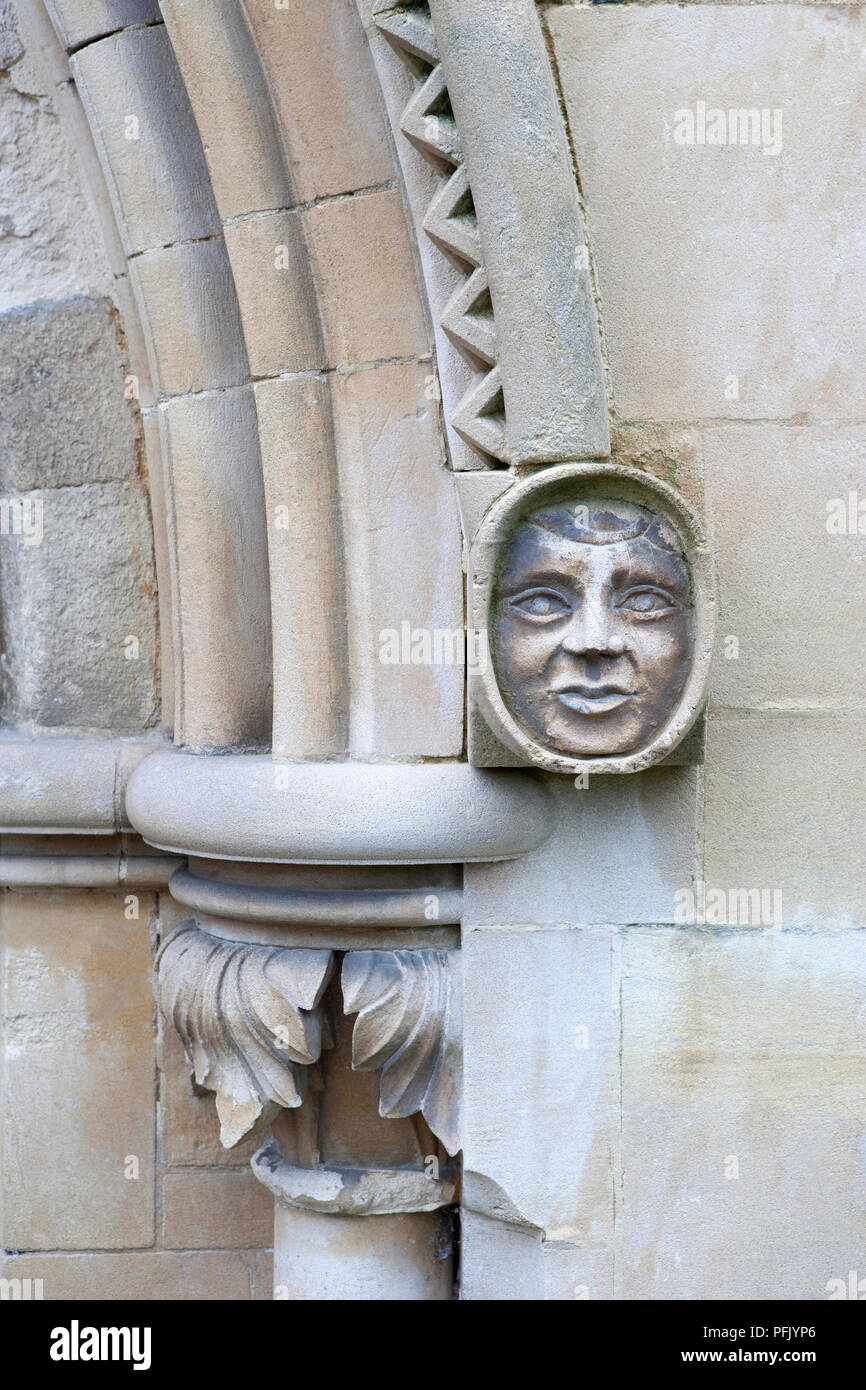 Great Britain, England, Hampshire, Romsey, Romsey Abbey, stone carving of a face beside a stone pillar with mouldings Stock Photo