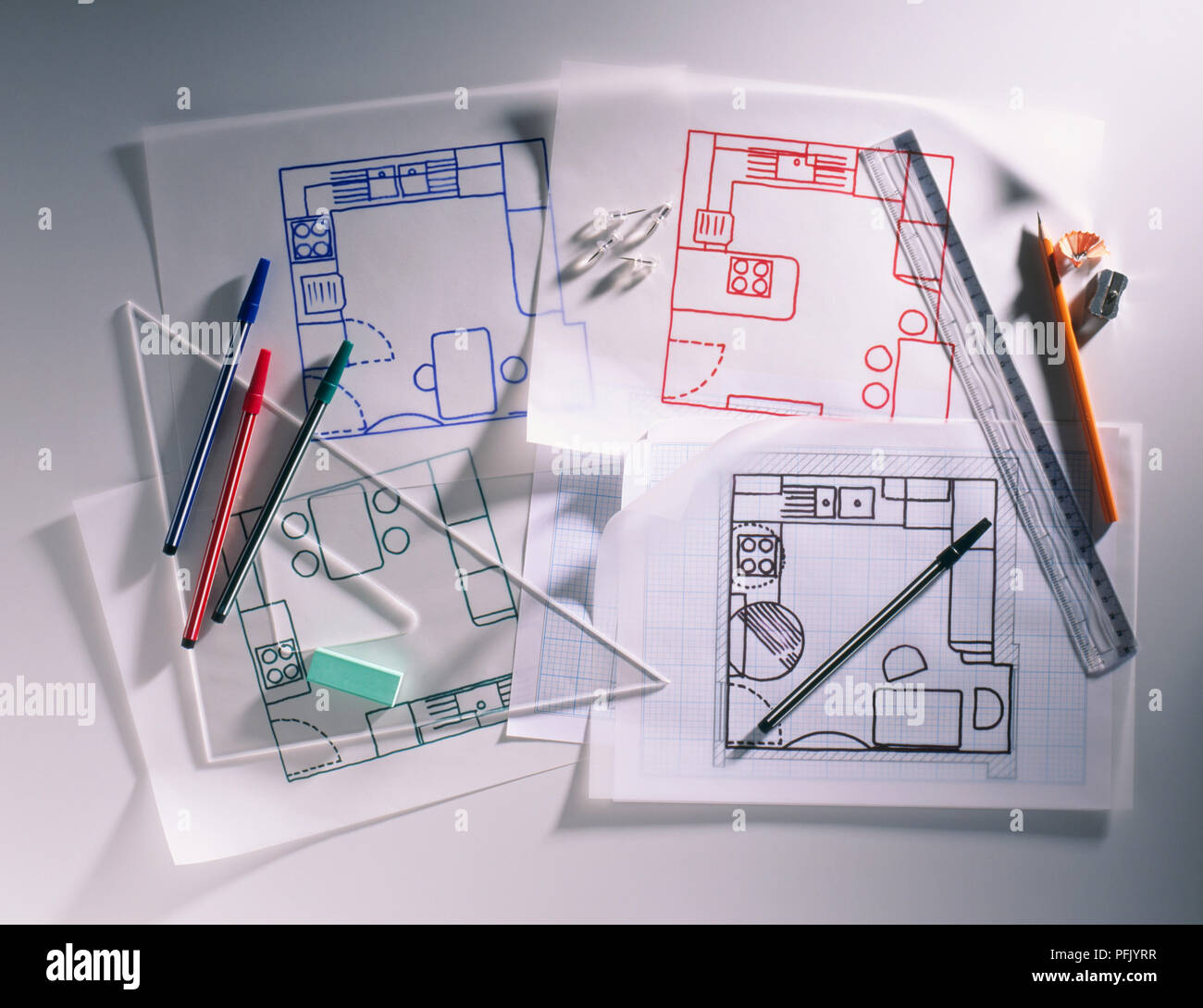 Four designs for a kitchen with drawing materials on top, including set square, ruler, pens Stock Photo
