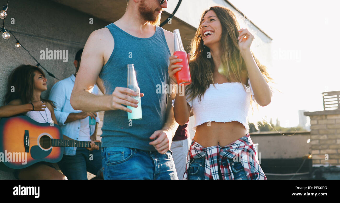 Friends having fun at rooftop party. Stock Photo