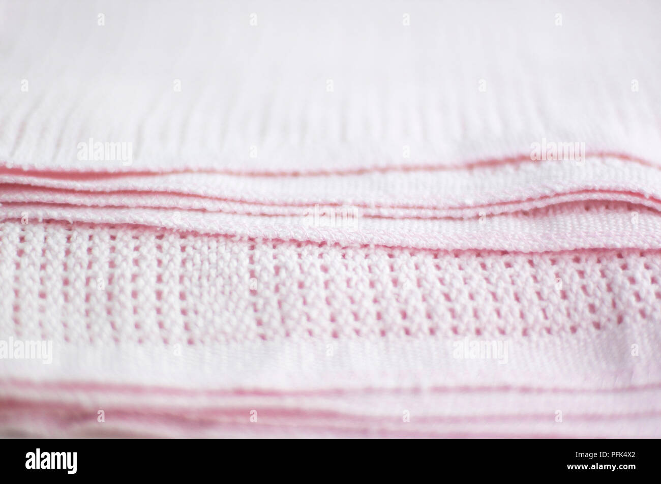 Pink cellular baby blanket, folded up, close-up Stock Photo