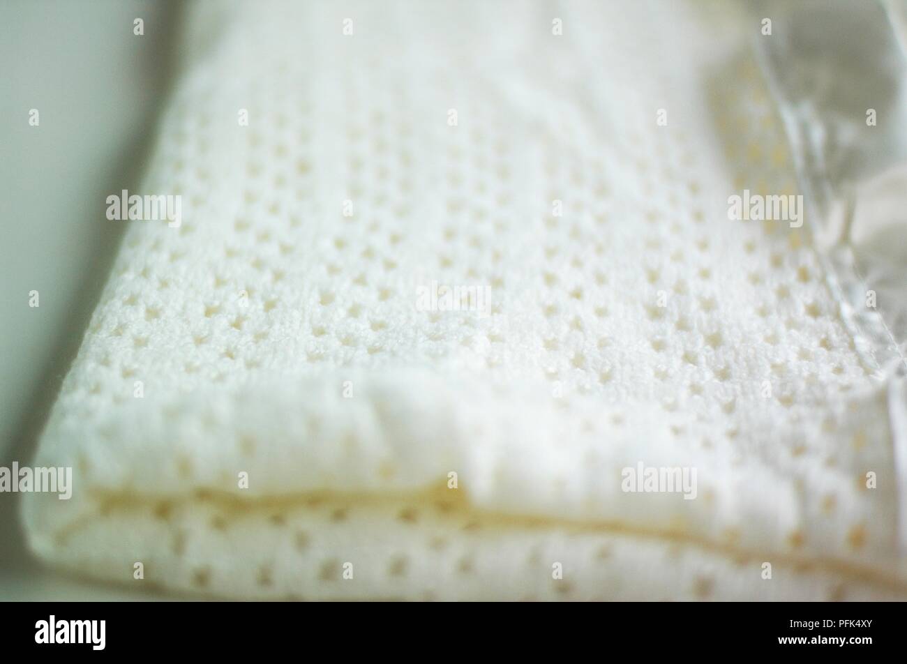White cellular blanket, folded up, close-up Stock Photo