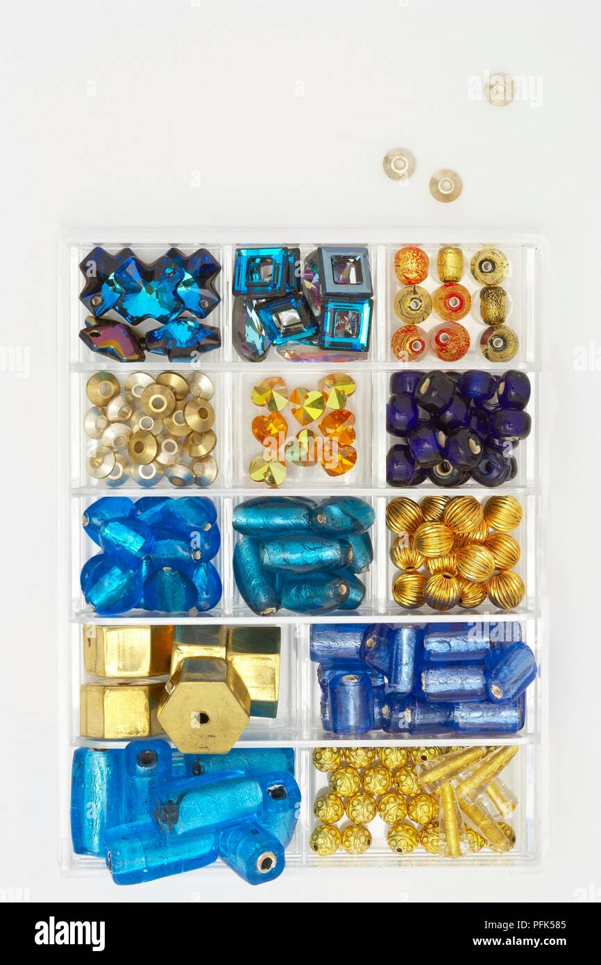 Bead box containing wide variety of differently shaped beads, including foiled and frosted beads Stock Photo