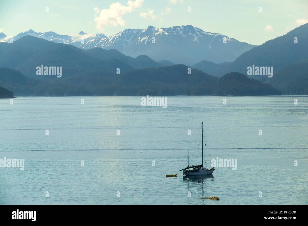 USA, Alaska, fishing boat off mountainous coast Stock Photo