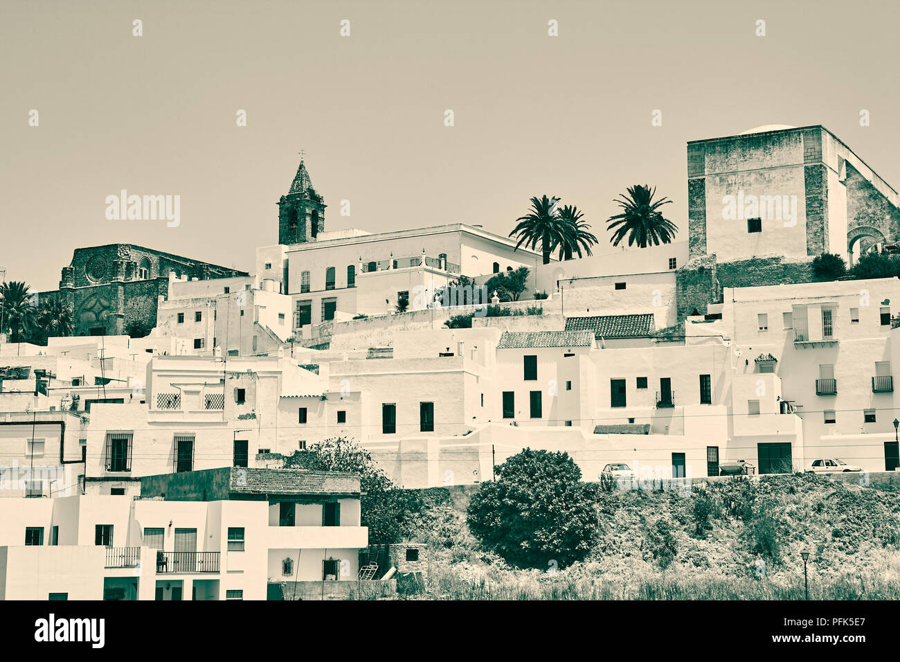 A view of a spanish hilltop village.  Angular lines and square whitewashed buildings with rectangular windows Stock Photo