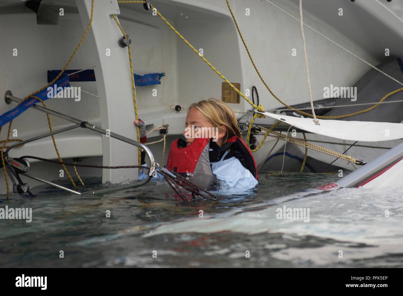 Young woman wearing life jacket in capsized dinghy Stock Photo Alamy